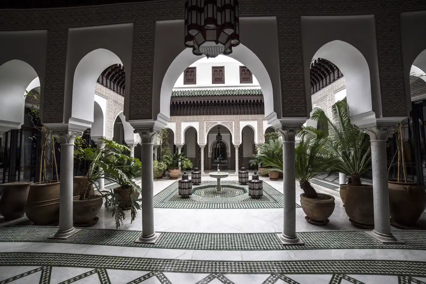 Gala dinner in a lantern-lit riad courtyard at night delivered end-to-end by Morocco Quest in Marrakech